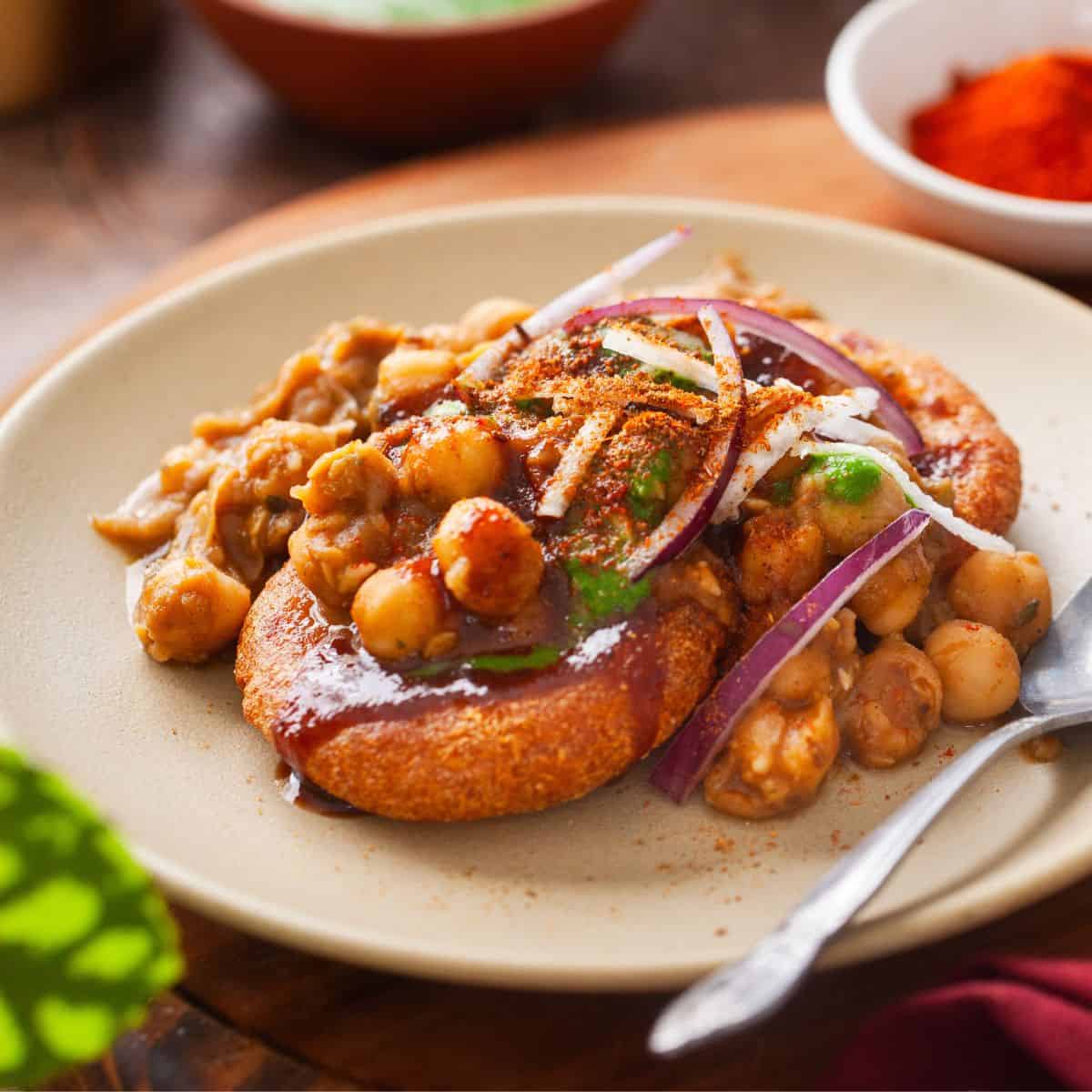 Aloo tikki served with chutneys and yogurt